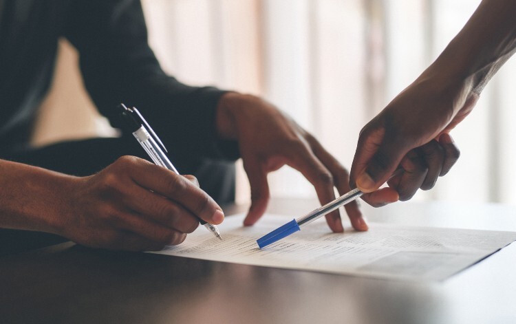 Two people filling in a form