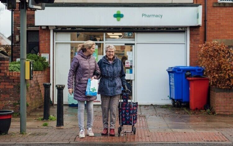 patients stood outside a pharmacy