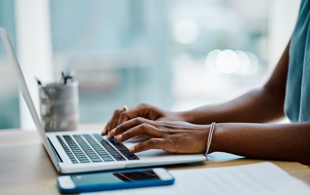 Person typing on computer looking at resources