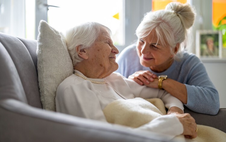 Elderly woman with her caregiver at nursing home