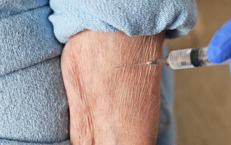 person's arm being vaccinated