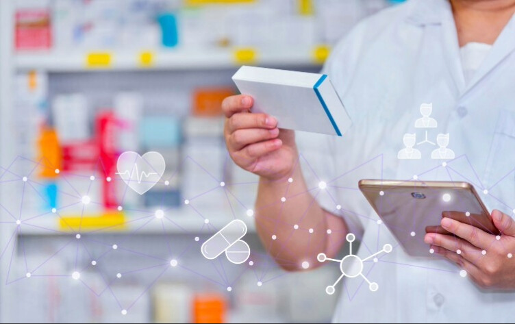 Pharmacist looks at a medicine packet in a pharmacy