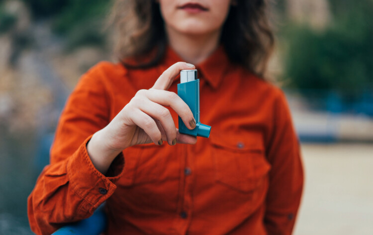 Woman holding an inhaler