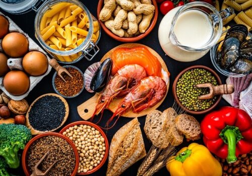 Most common allergens food shot from above. The composition includes fish, crustaceans mussels, peanut, eggs, milk soy products, bee pollen, nuts, wheat and derivates and sesame.