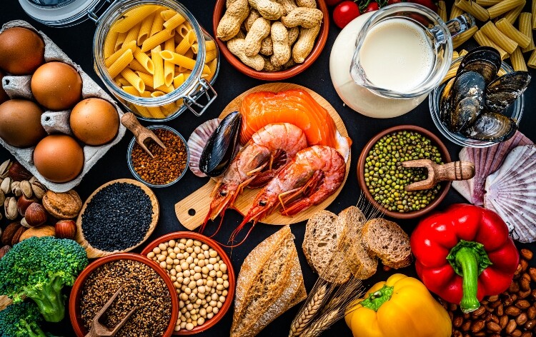 Most common allergens food shot from above. The composition includes fish, crustaceans mussels, peanut, eggs, milk soy products, bee pollen, nuts, wheat and derivates and sesame.