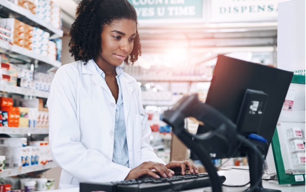 Pharmacist typing in pharmacy