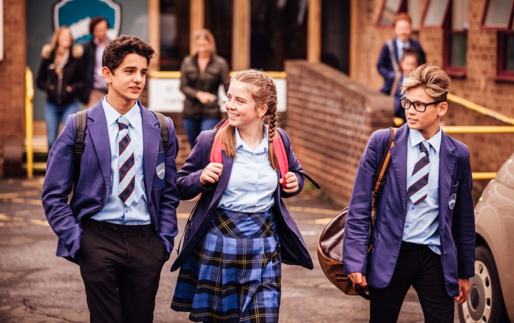 Teenagers school children walking out of school
