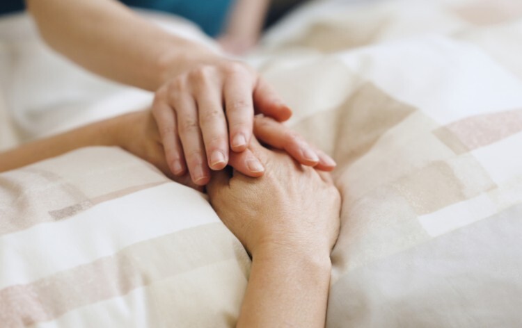 Healthcare professional supporting a terminally ill patient