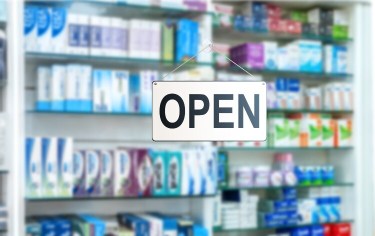 Open sign on a pharmacy window