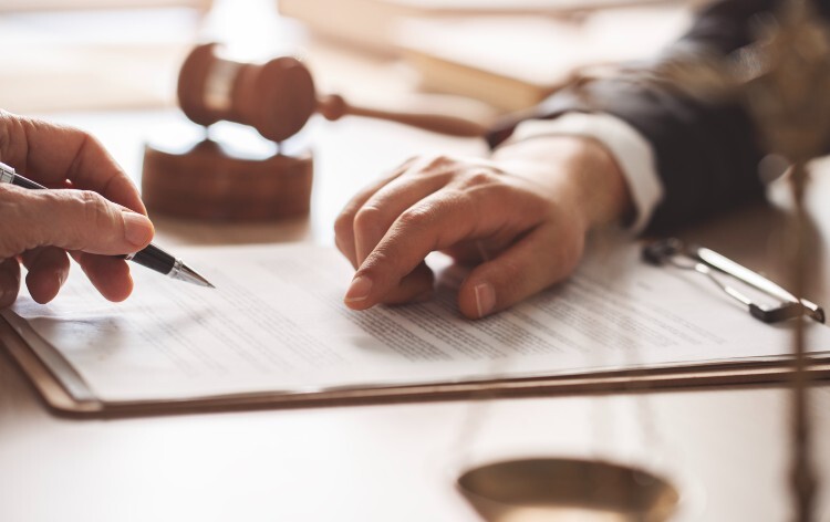 Two hands point at a document