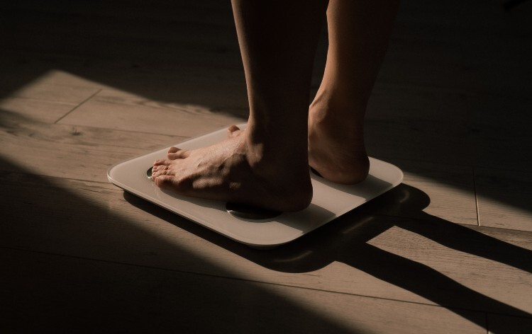 Person standing on weighing scales