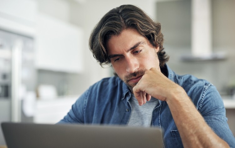 Man on laptop looking for ED medication