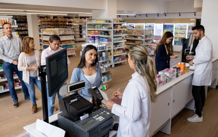 Long queue of people waiting in a pharmacy