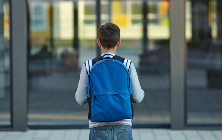 Young boy wearing a rucksack