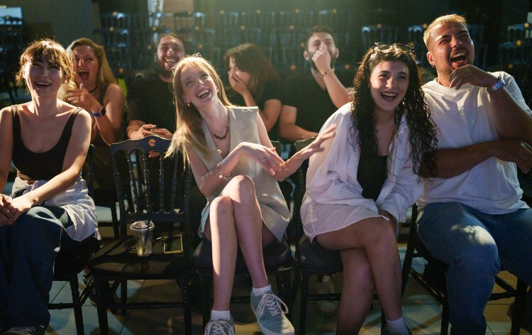 People laughing at a comedy show