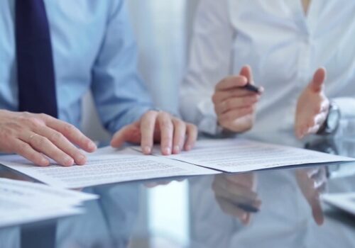 People looking at pieces of paper in a meeting