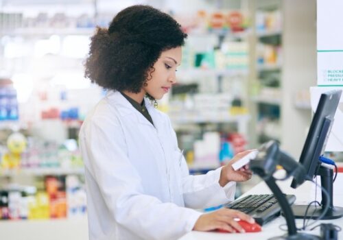 Pharmacist looking at a computer