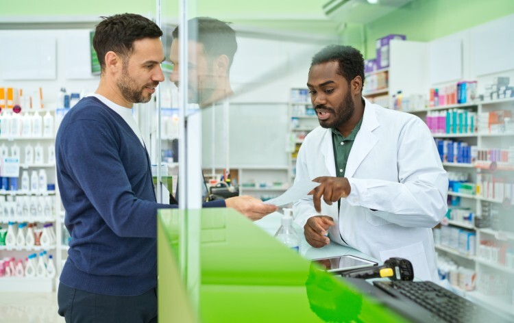 Man talking to pharmacist