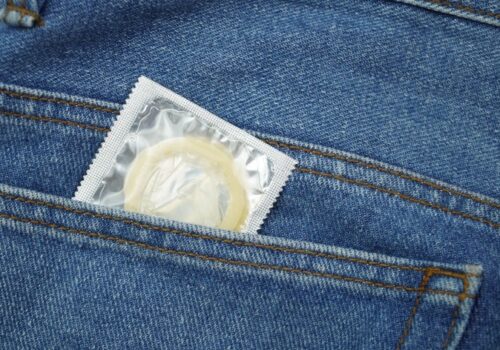 Close-up of a condom packet inside a jeans back pocket