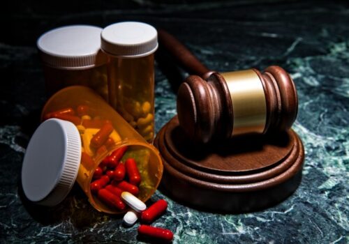 Court room gavel on green marble with prescriptions - stock photo