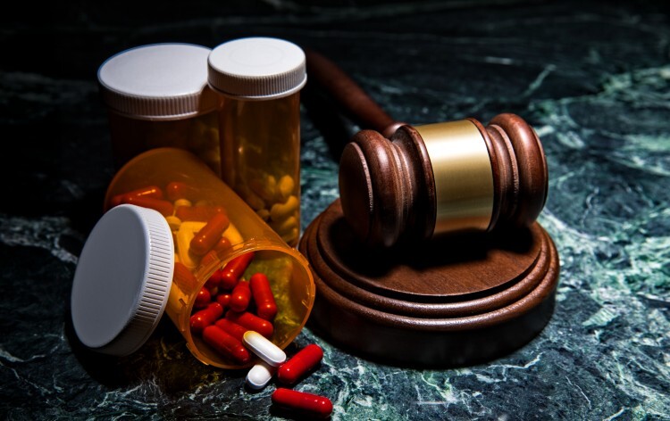 Court room gavel on green marble with prescriptions - stock photo