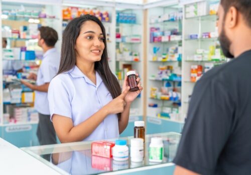 Pharmacist explains medicine to customer