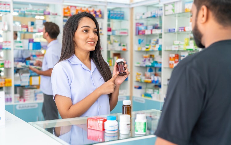 Pharmacist explains medicine to customer