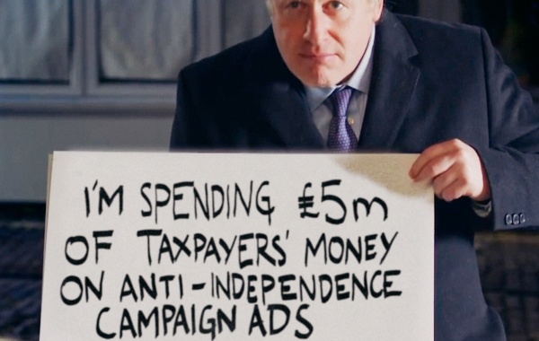 Boris Johnson holding a sign saying "i'm spending £5m of taxpayers money on anti-independence campaign ads"