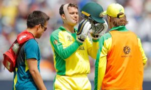 Alex Carey gets patched up after being struck his helmet by a Jofra Archer delivery at Edgbaston. Photograph: Tom Jenkins/The Guardian