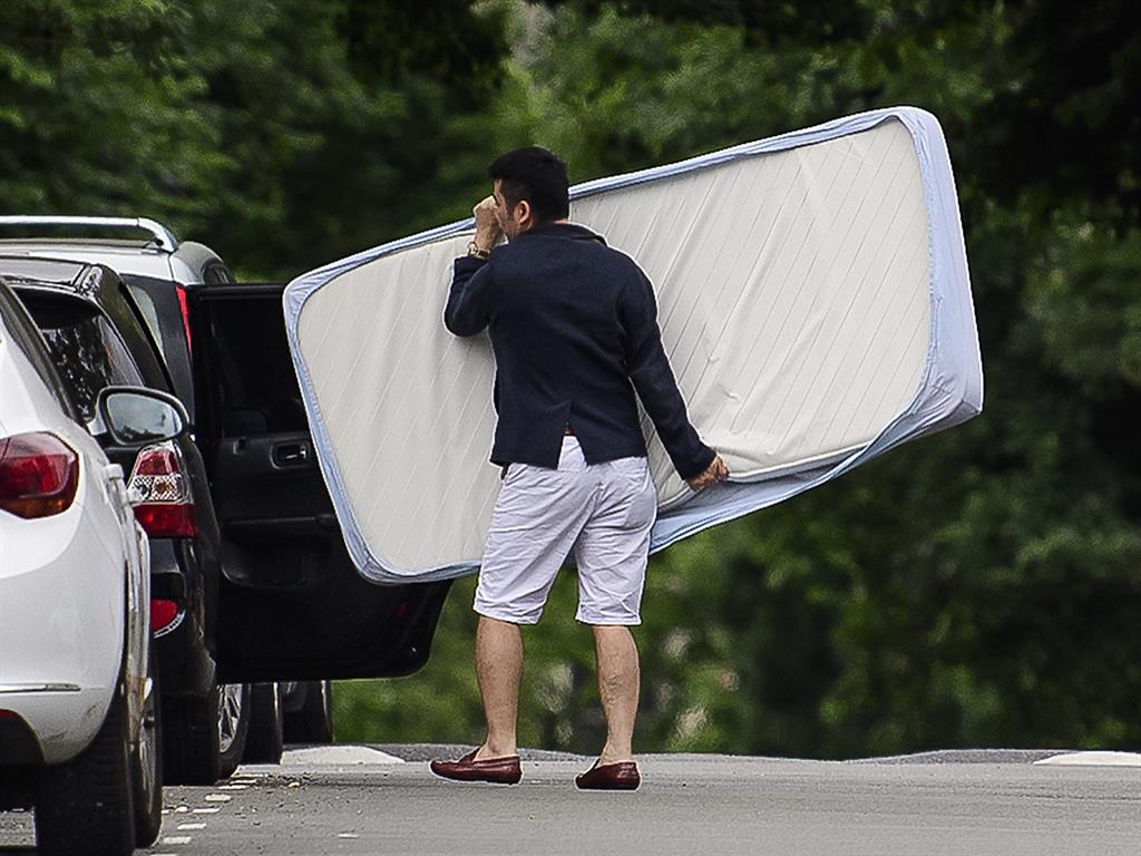 Out An exacuee takes his mattress with him