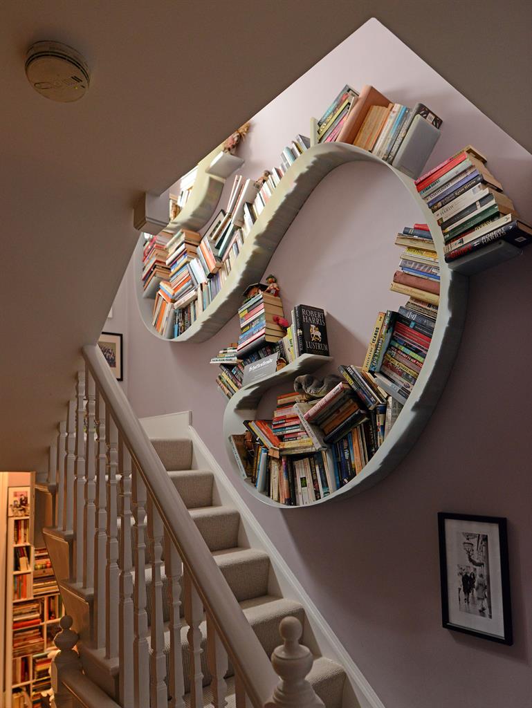 Curl up with a book: The curvy bookshelf is a befitting focal point, so you can grab a book to read as you walk up the stairs