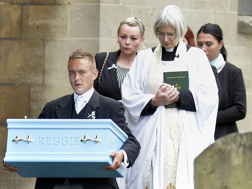Ryan Young carrying the coffin of his son Reggie after his funeral service PICTURE: PA