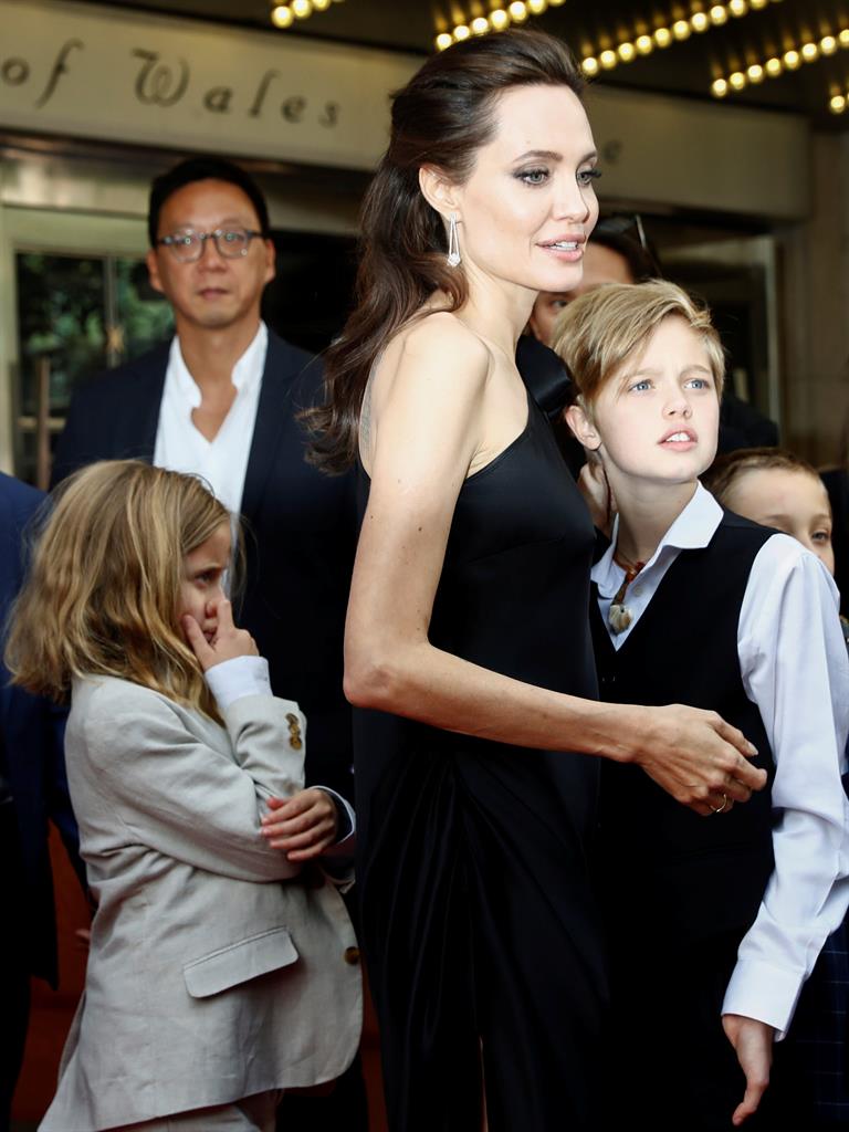 Director Angelina Jolie arrives on the red carpet with her children Vivienne Jolie-Pitt (left) and Shiloh Jolie-Pitt (right)