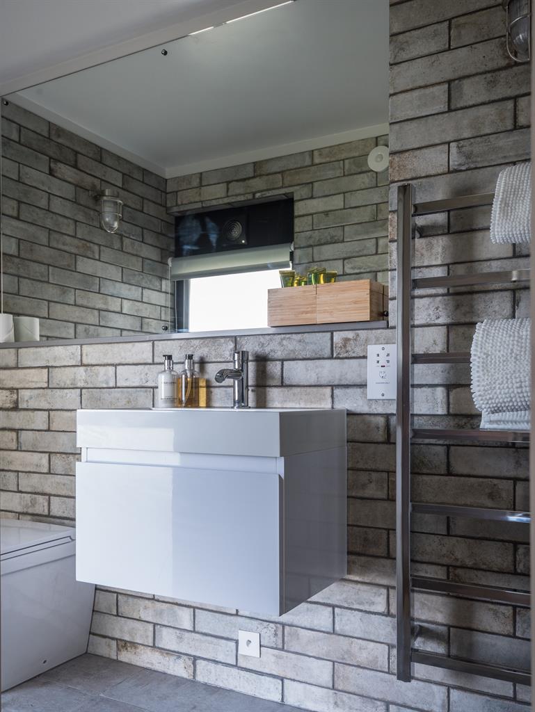 Clean lines: The crisp, 1960s style is used to striking effect in the bathroom, above, and on the outside terrace