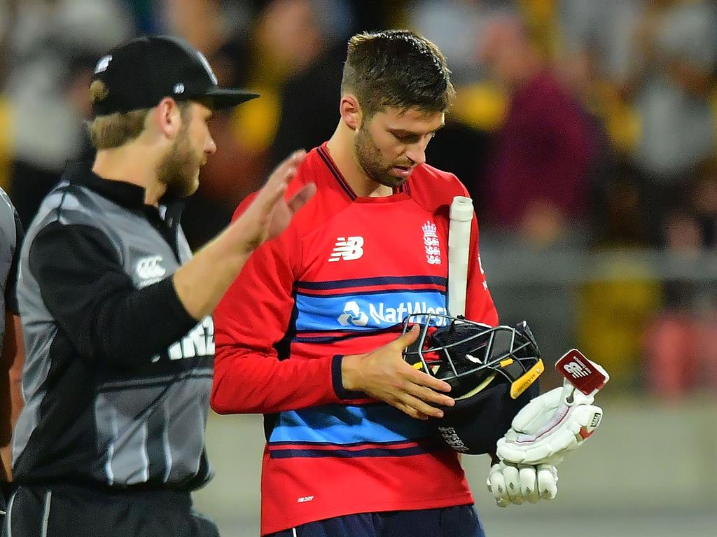 Dejected: England's Mark Wood (right) is consoled by New Zealand's Kane Williamson PICTURE: GETTY