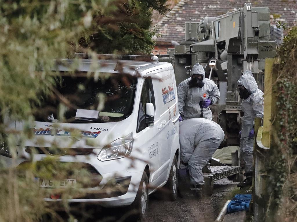 ‘Like something from The Twilight Zone’: Police and soldiers remove a van in Winterslow PIC: AP