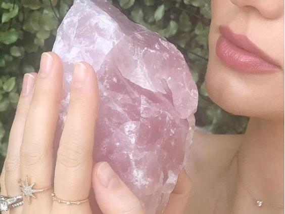 Feel the quartz: Miranda Kerr on Instagram with a rose quartz; and (below) Victoria Beckham revealing the obsidian crystal she carries in her handbag