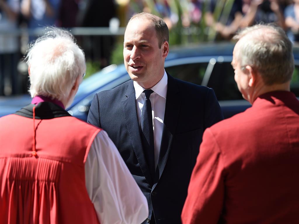 Greetings: The Prince arrives for the service and, below, Theresa May shakes hands with the Dean of Manchester