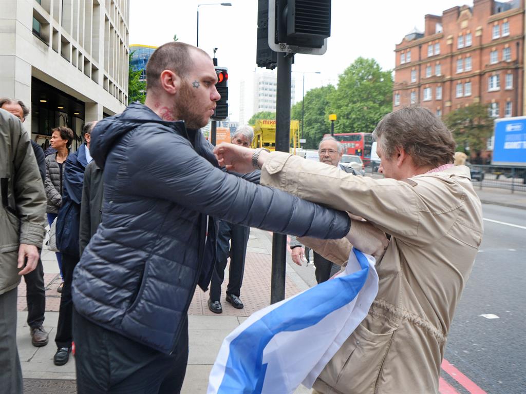 Tempers fray: Scuffles ensued outside Westminster Magistrates' Court today PICTURES: PA