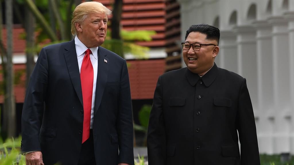 In good spirits Kim Jong-un walks with Donald Trump during a break in talks