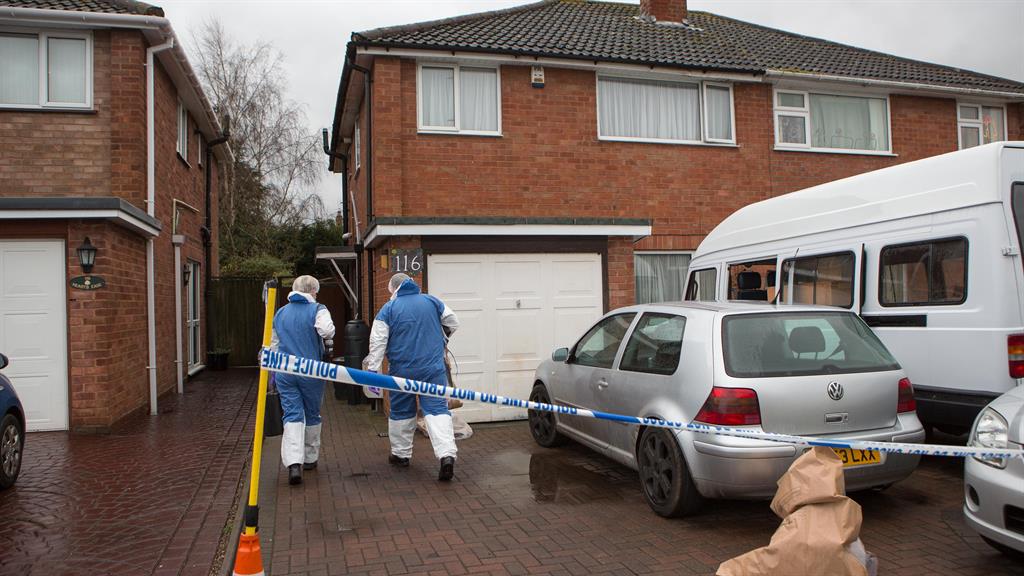 Sealed off: Police at house in Bromsgrove on New Year’s Day after stabbing