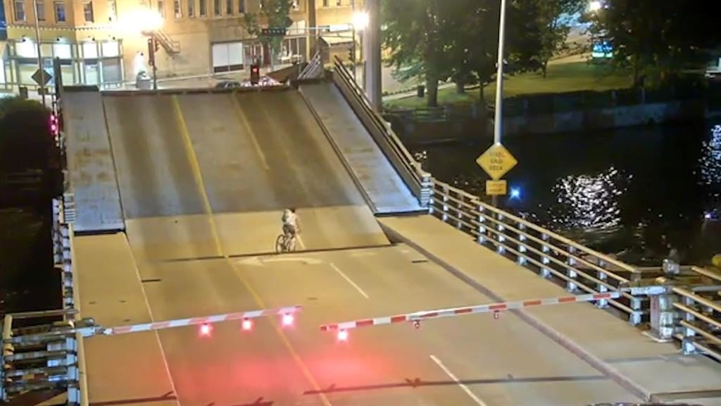 Cyclist falls into gap as bridge opens to let boat through