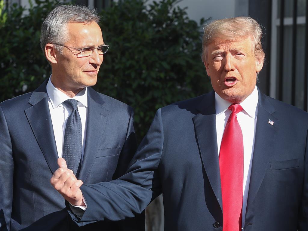 Pressing his point: NATO secretary general Jens Stoltenberg looks on as Donald Trump puts his views across PICTURE: EPA