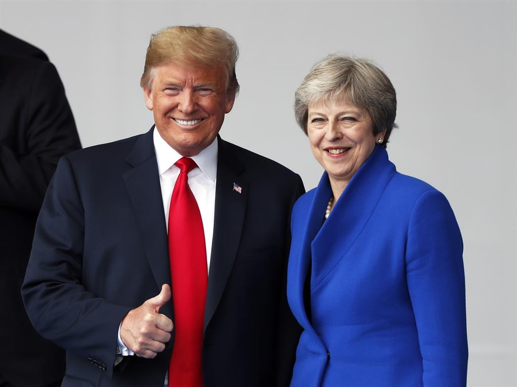 Thumbs up: Mr Trump chats with Theresa May at the NATO summit in Brussels PICTURE: EPA