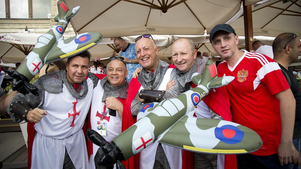 Flying high: Nostalgic England fans pose for a photo with a Russian fan