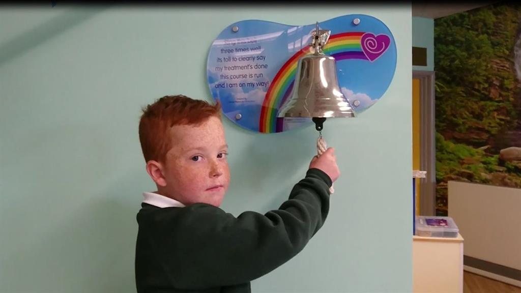 New horizons: Sam Sharland rings the bell as he leaves hospital PICTURE: SWNS