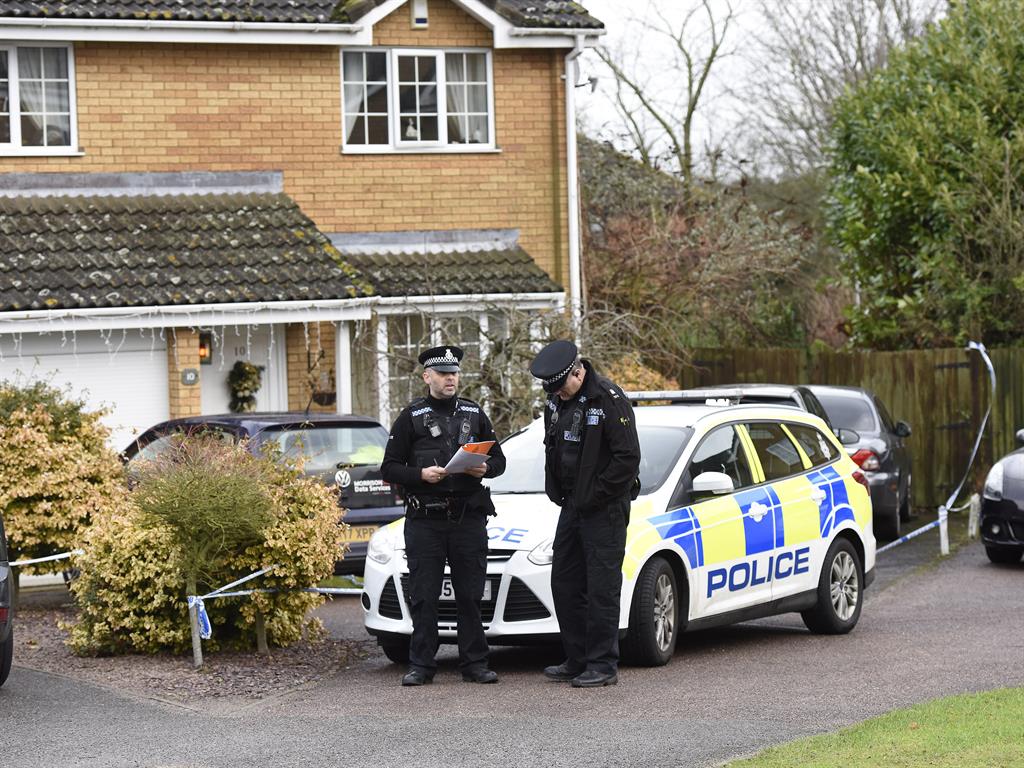 Crime scene: Police outside the couple's house in December, where Anne Searle's body was found