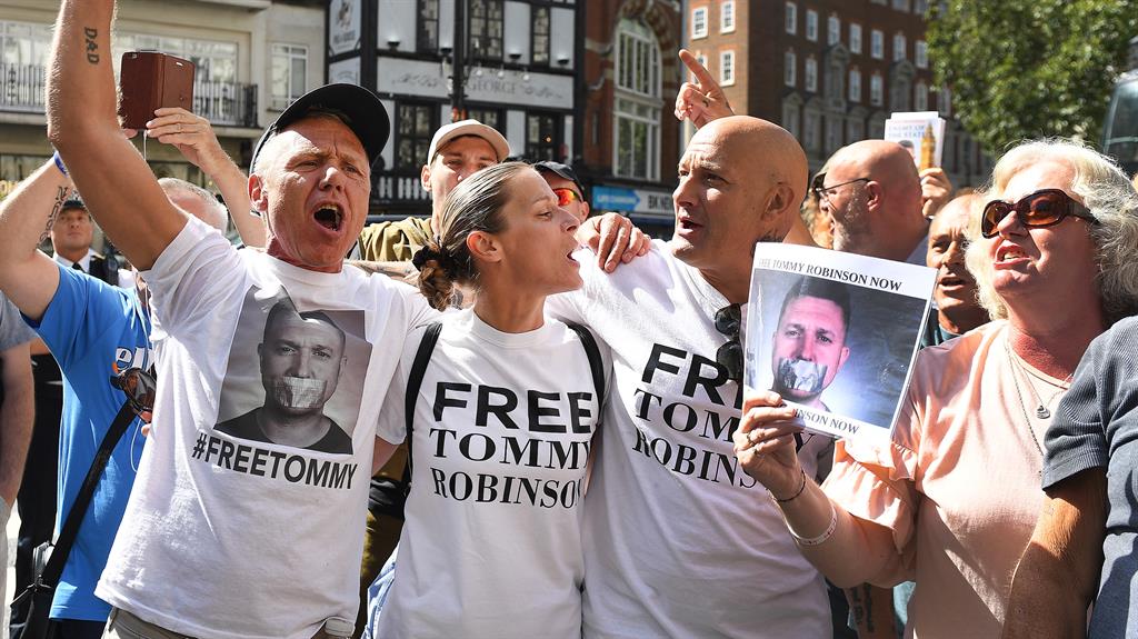 Splits: Tommy Robinson supporters celebrate outside the High Court in London, while below anti-fascists demonstrate nearby PICTURES: EPA/AP