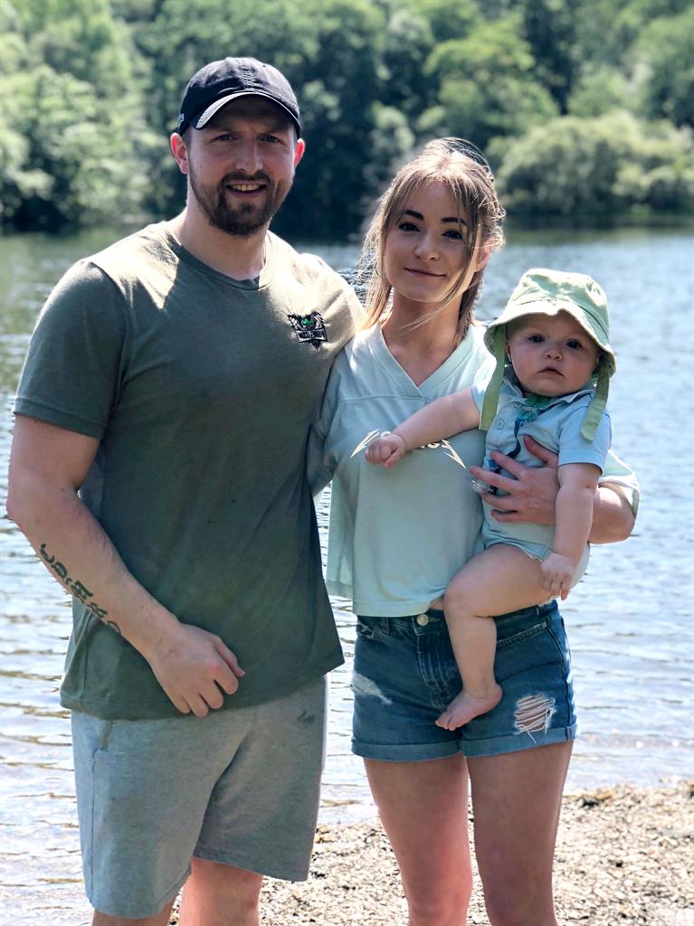 Back in shape: Sion with his partner Kara Williams and their son Tedi