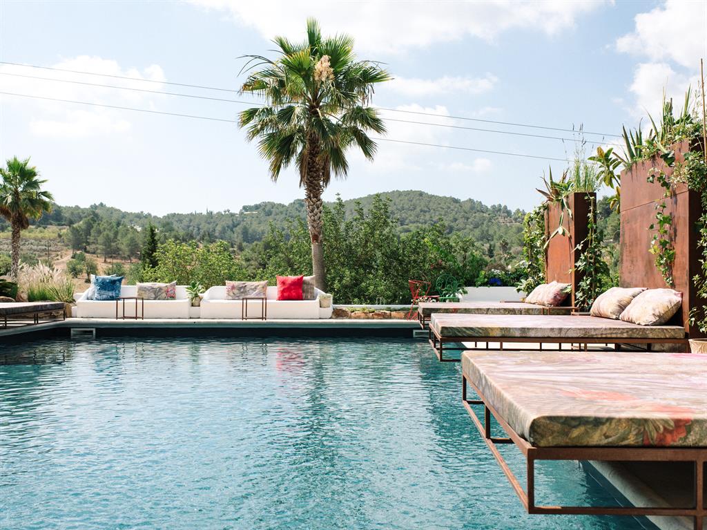 Any old iron: Rusted metal loungers are a feature of the pool